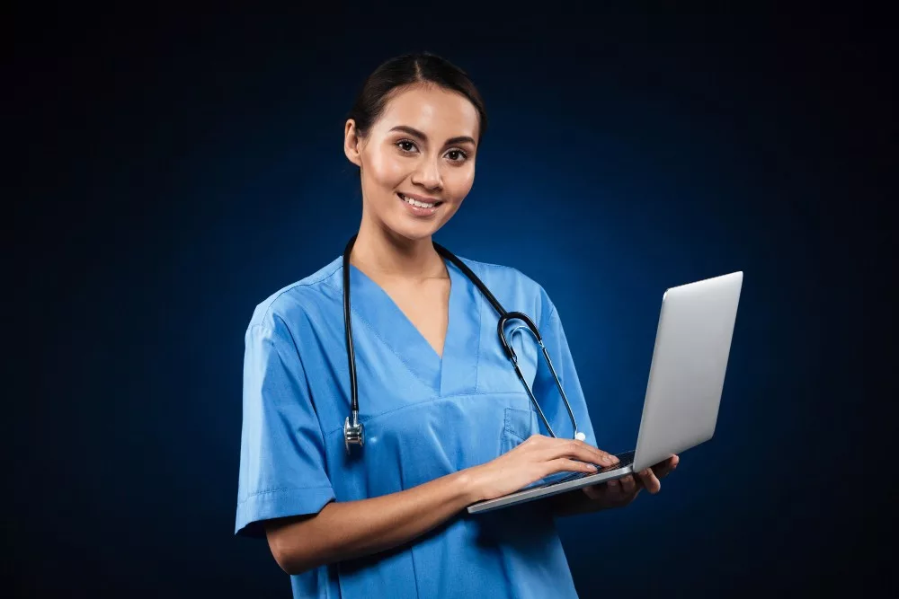 lady assistant in medical uniform using laptop